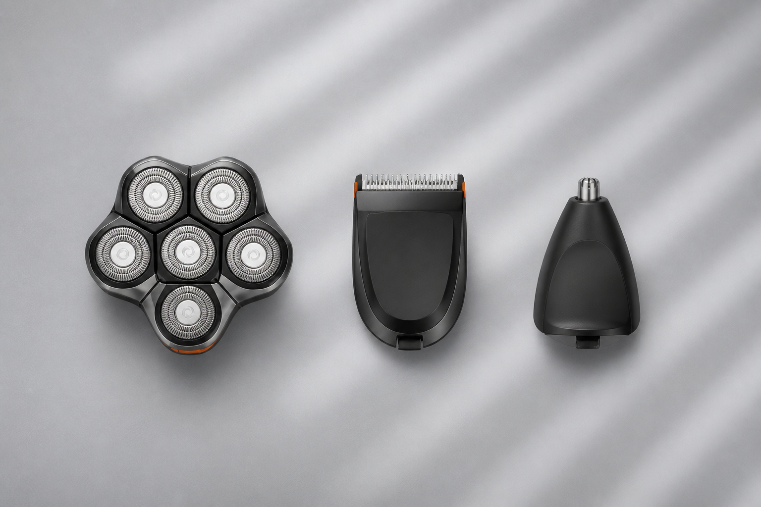 The three interchangeable snap-on heads: shaver, beard trimmer, and nose & ear trimmer